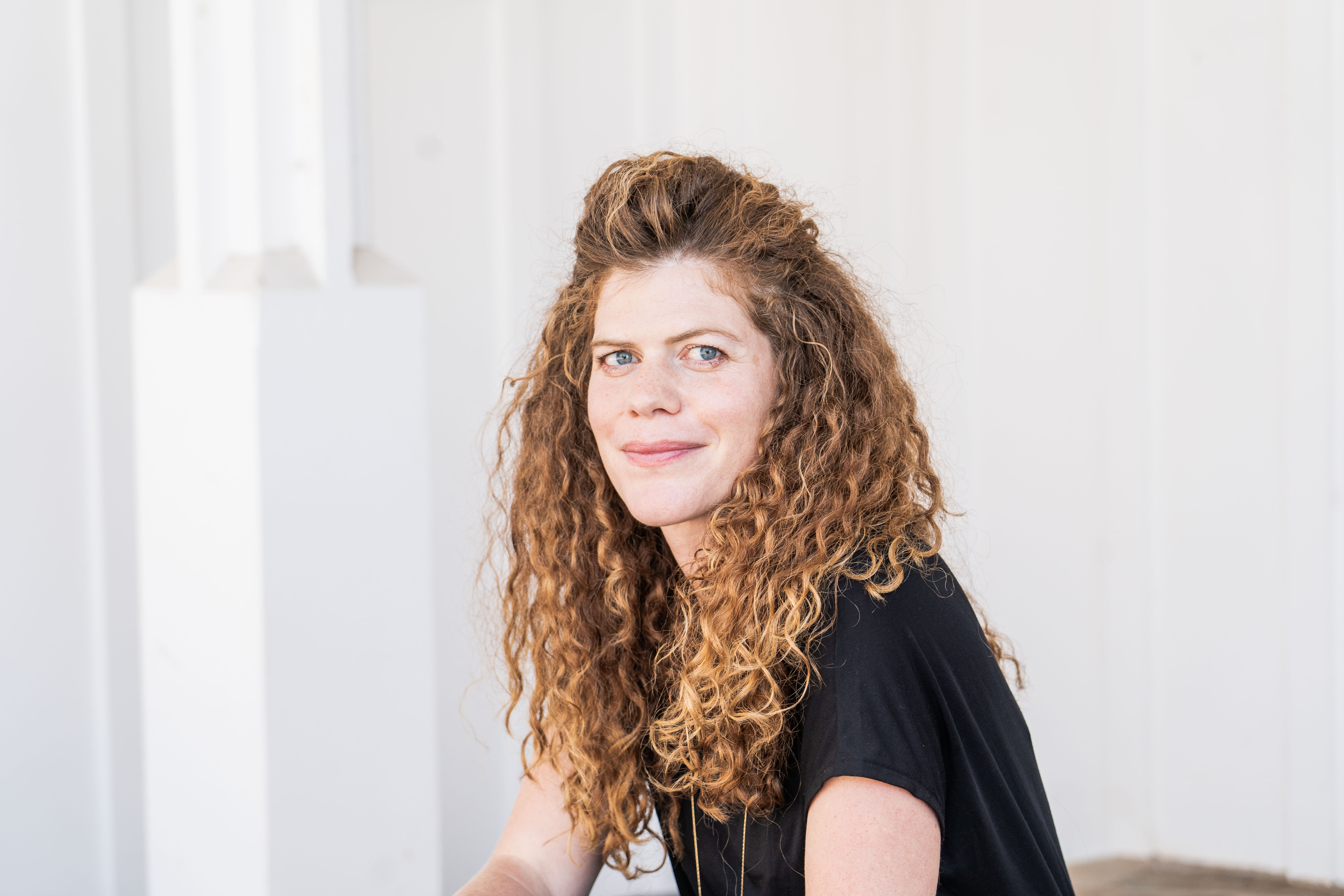 Portrait of a female lecturer surrounded by books