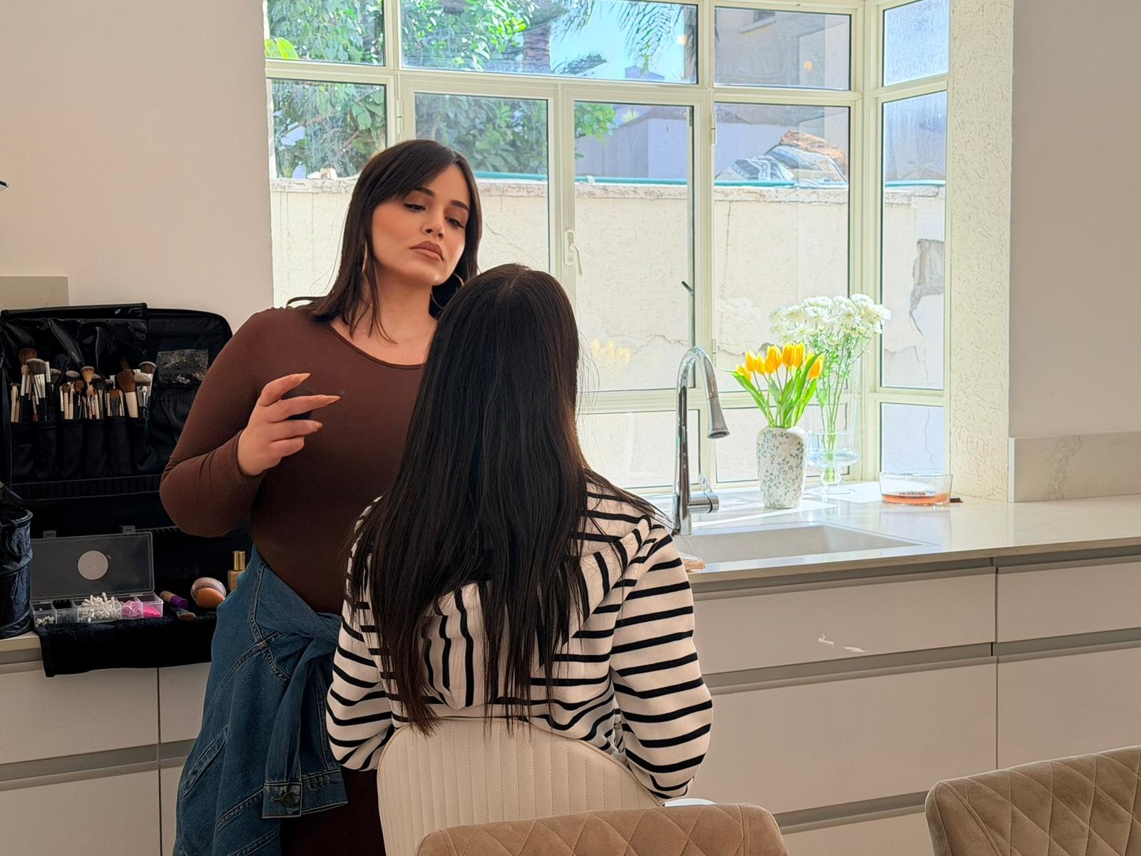 Professional Makeup Artist, working on client in studio